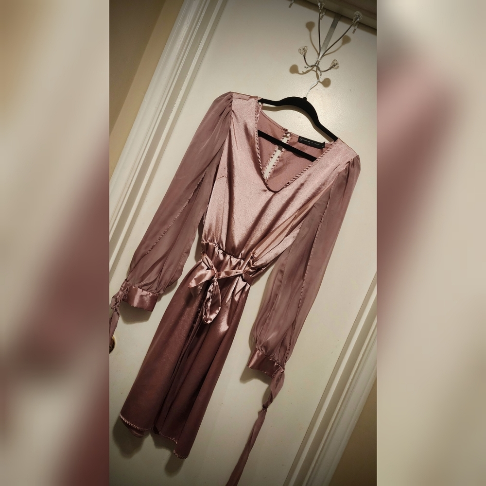 Beautiful in blush, this one-piece polyester dress exudes confidence. Incdg sash